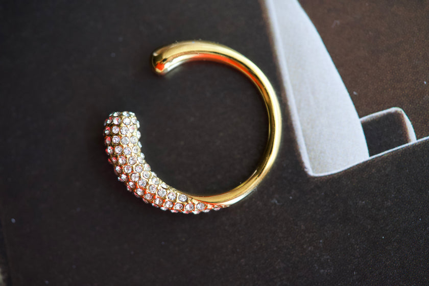 Gold-tone crystal curve ring with full rhinestone band and open C-shaped design
