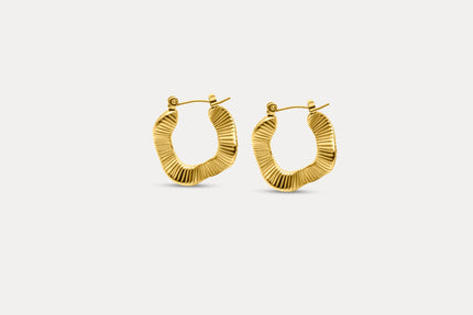 Gold textured hoop earrings with ridged oval profile and clasp back