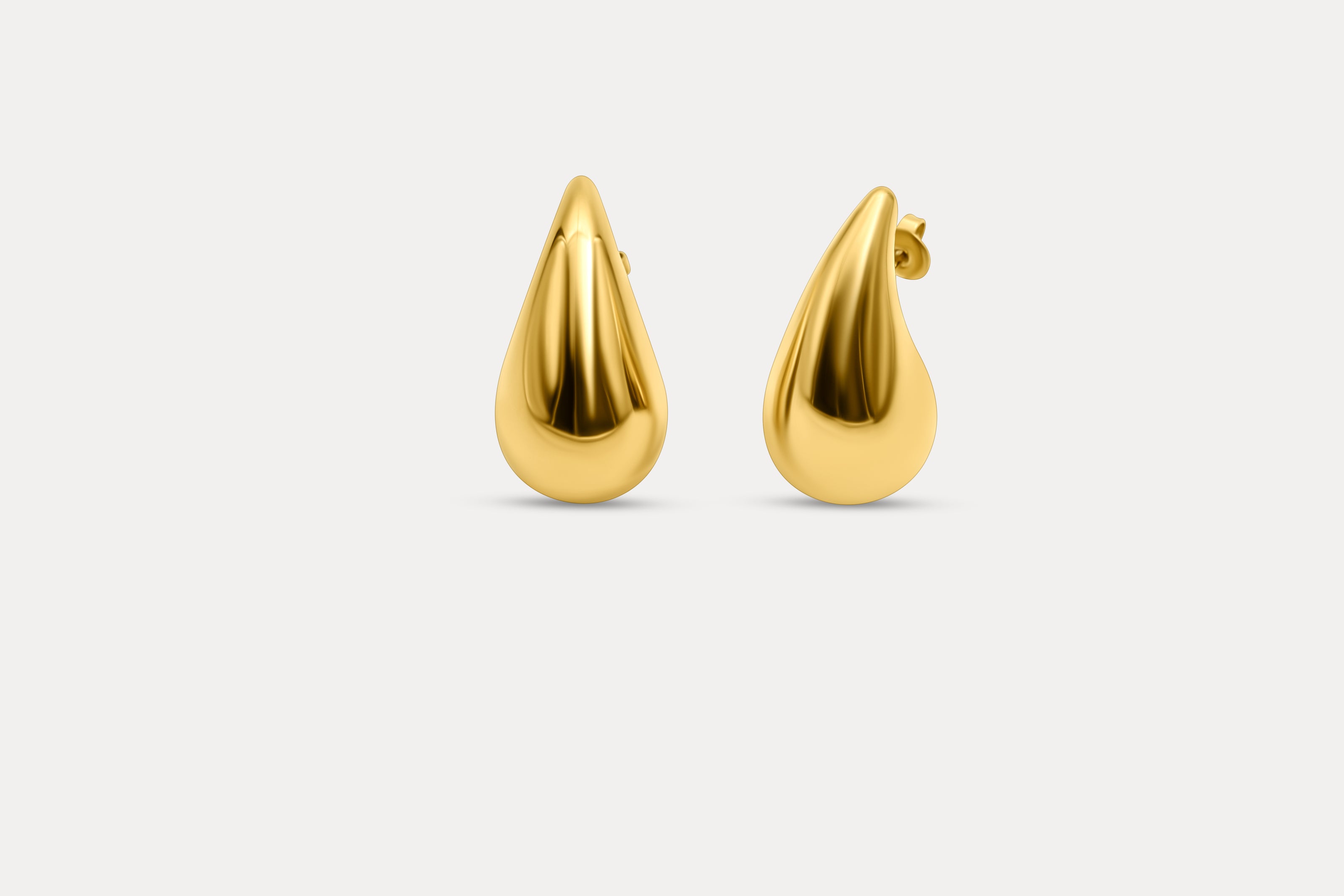 Gold teardrop stud earrings with sculpted glossy drop silhouette
