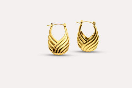 Pair of gold wave sculpted hoop earrings with ribbed swirl texture