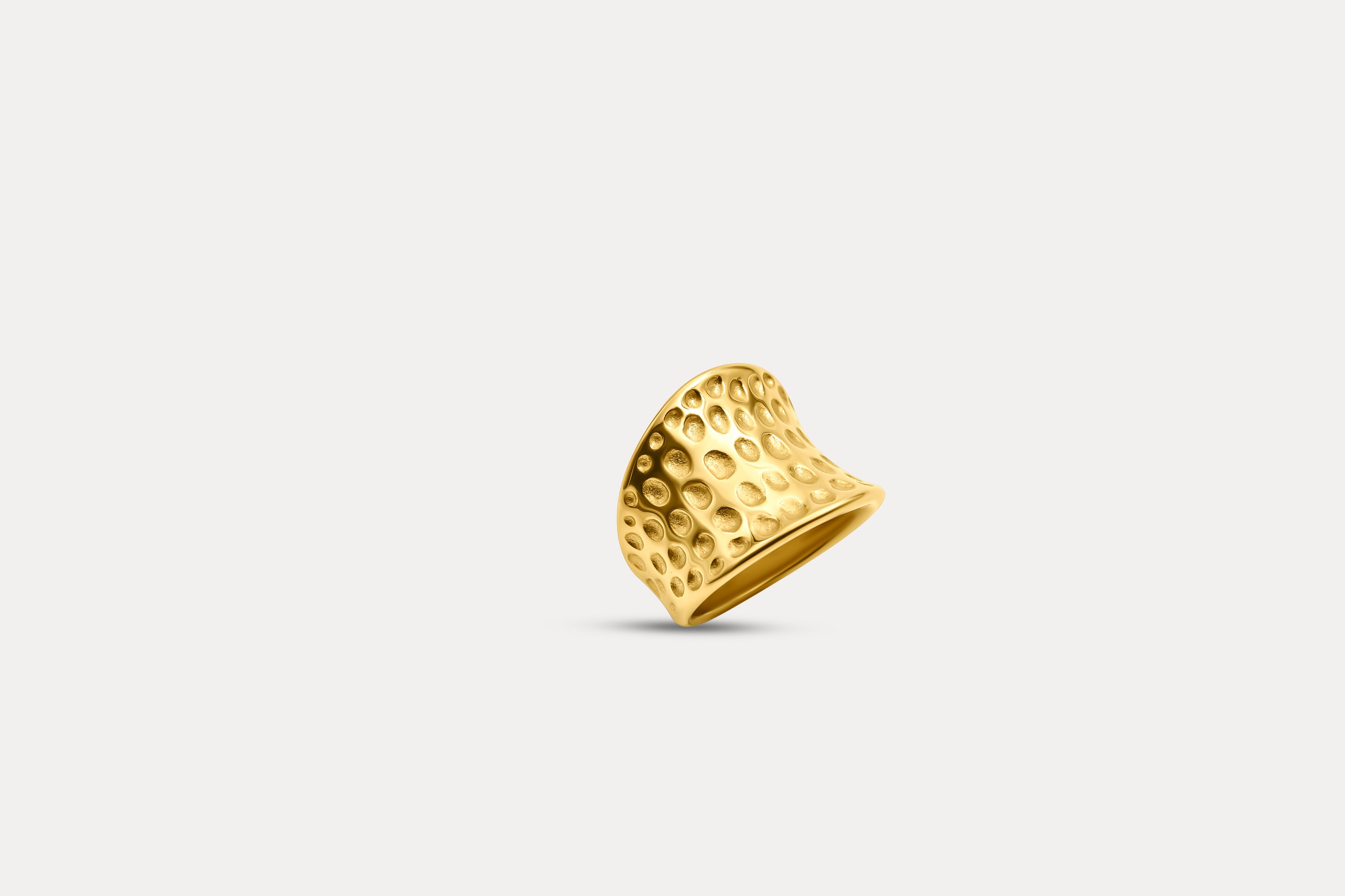 Gold hammered band ring with textured surface and heart-like profile