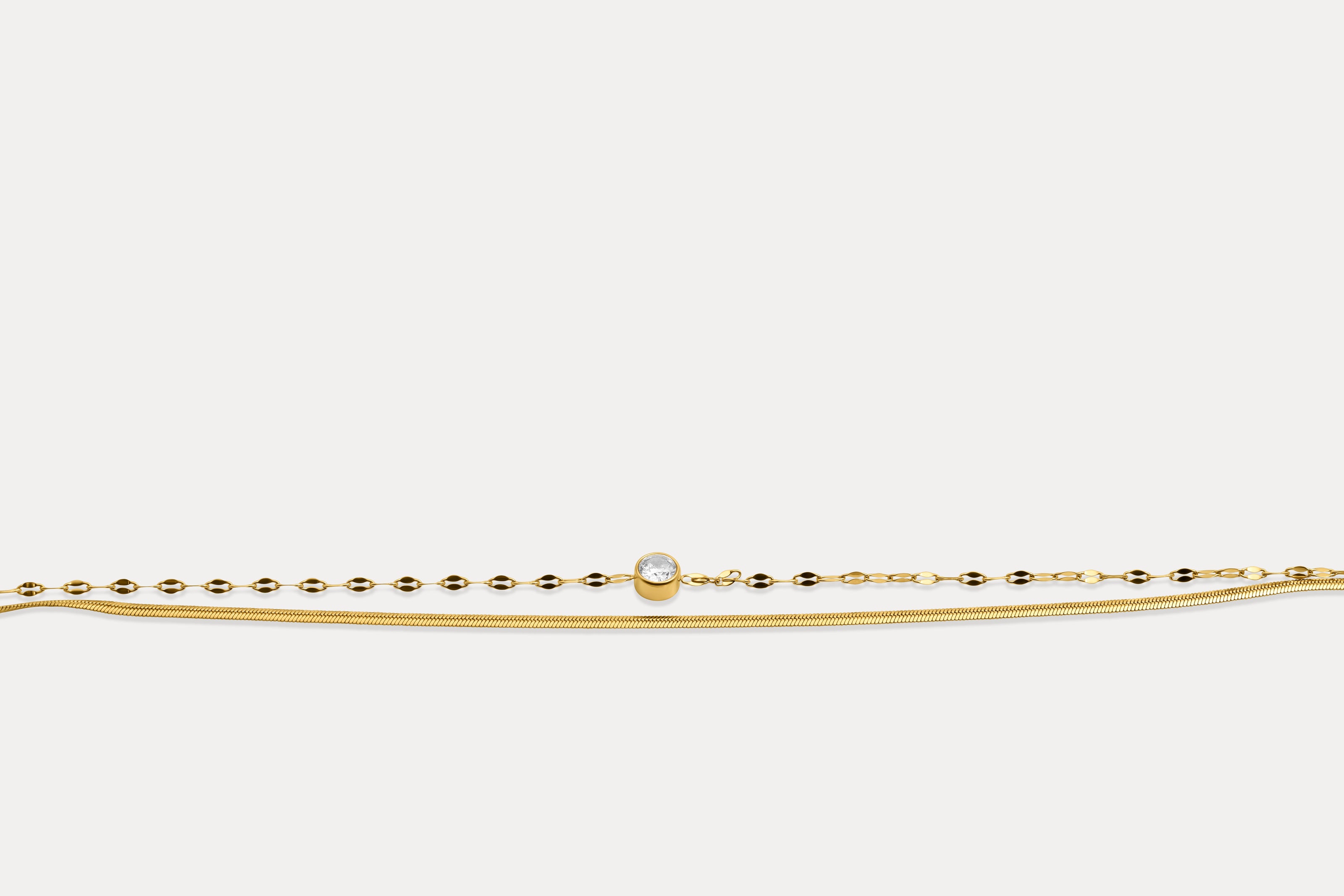 Gold double chain bracelet with round gemstone on fine linked band