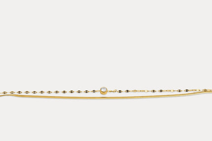 Gold double chain bracelet with round gemstone on fine linked band