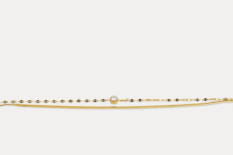 Gold double chain bracelet with round gemstone on fine linked band