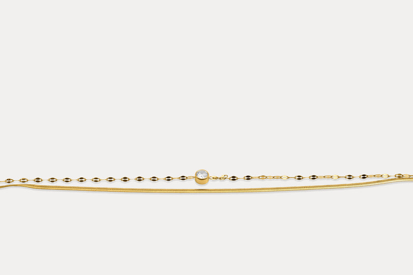 Gold double chain bracelet with round gemstone on fine linked band