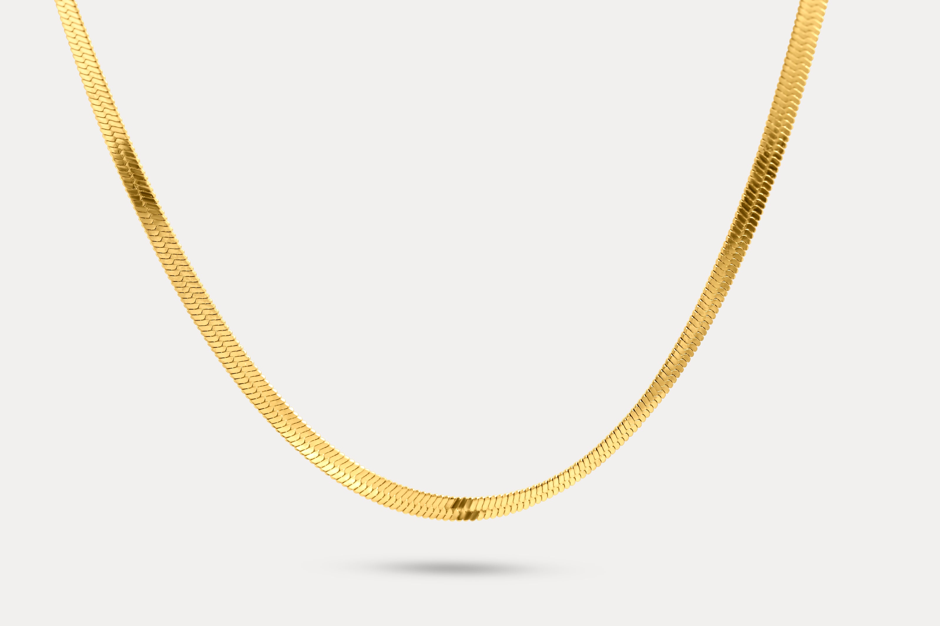 Snake chain necklace in gold-tone metal links, shown laid out