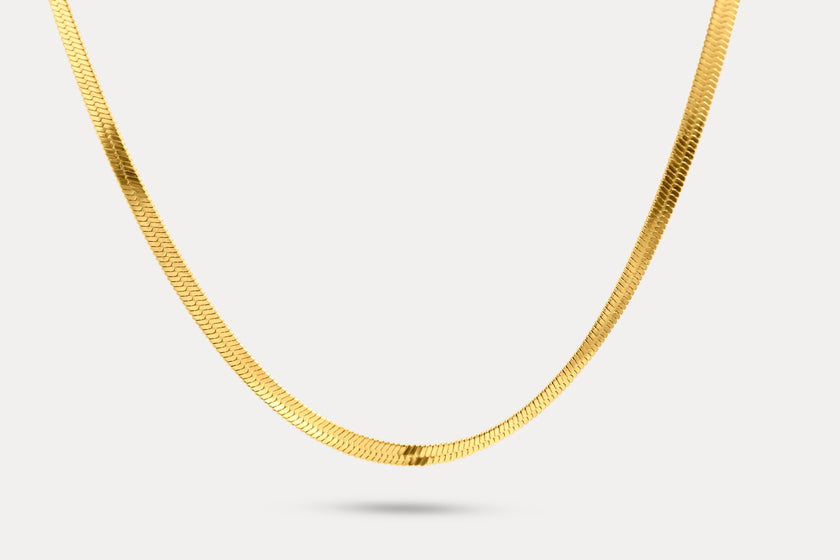 Snake chain necklace in gold-tone metal links, shown laid out