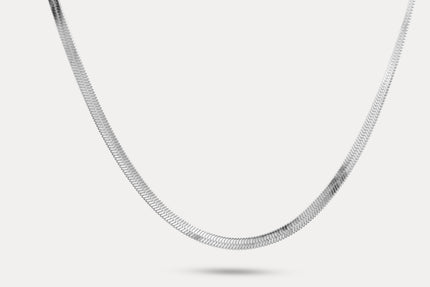 Snake chain necklace in silver-tone metal links, shown laid out