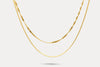 Gold double-layer chain necklace with fine links and curved front