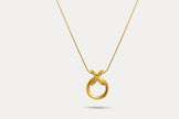 Circle pendant necklace with gold-tone round charm and interlocking X pendant