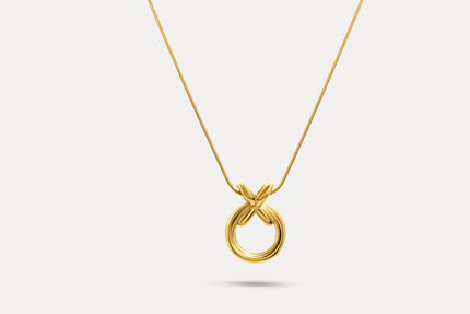 Circle pendant necklace with gold-tone round charm and interlocking X pendant