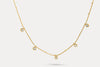 Gold charm necklace with evenly spaced round blue stone charms