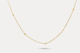 Gold chain necklace with tiny round crystal accents spaced along the length
