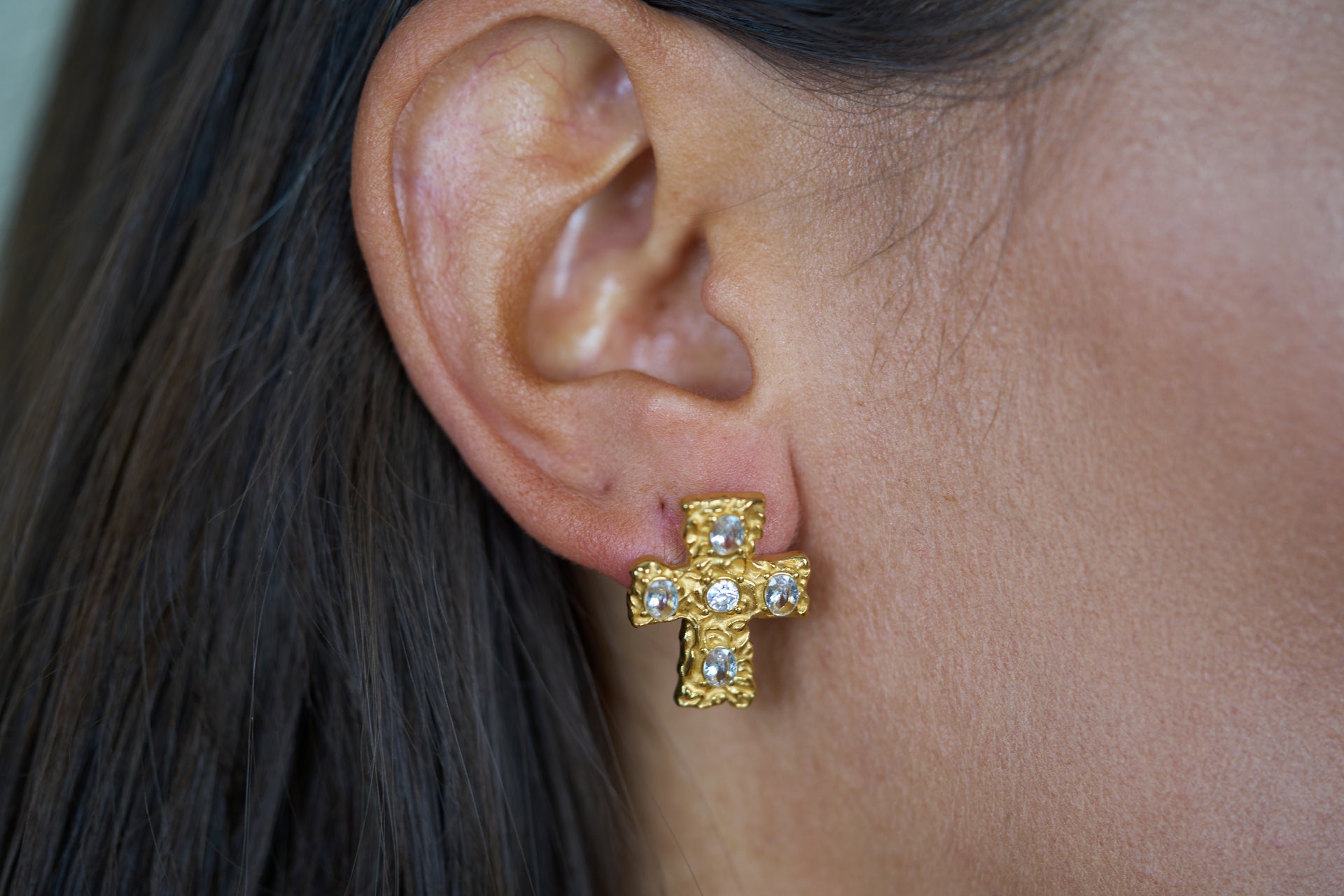 Gold textured cross stud earrings with blue crystal stones